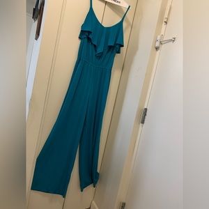 Pretty jumpsuit with ruffle collar tiny straps and elastic waist comfy material.